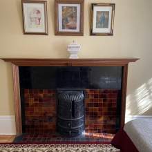 World's Fair Room cast iron fireplace with a surrounding ceramic tile